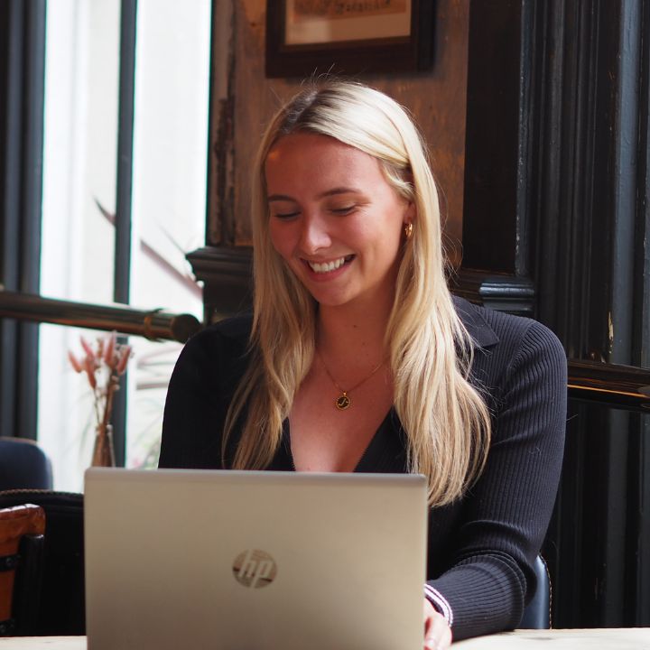 Female recruitment consultant smiling at her laptop